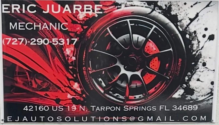 The back of his card: Eric Juarbe, Mechanic, the phone number, over a red and black wheel, with the address along the bottom